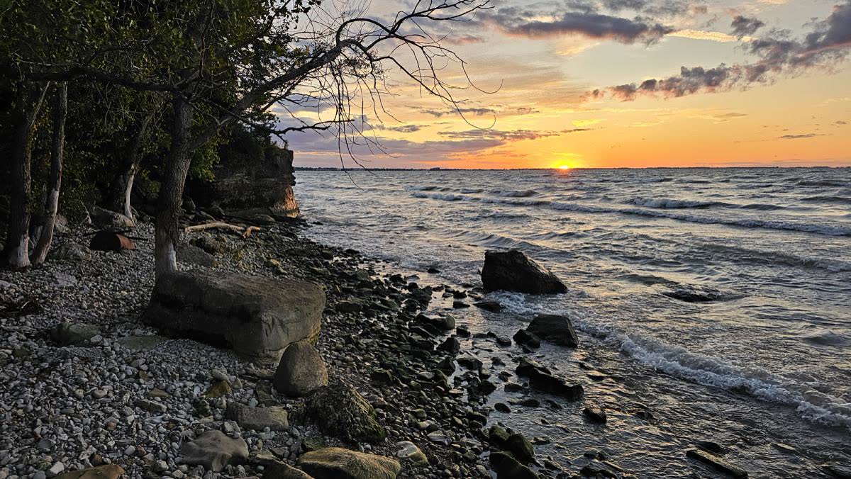 The rocky Lake Erie shoreline below the house at sunset
